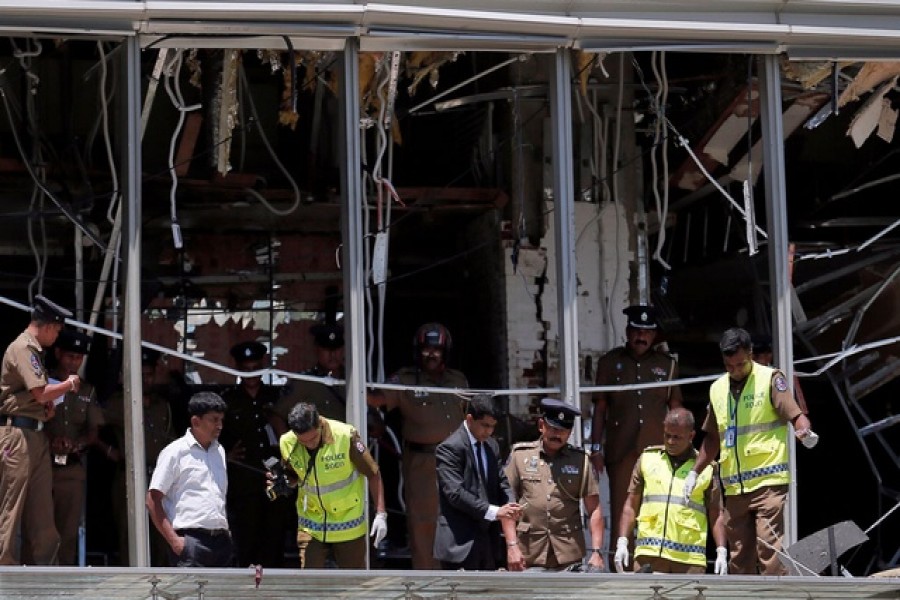 Crime scene officials inspect the explosion area at Shangri-La hotel in Colombo, Sri Lanka, April 21, 2019. Reuters
