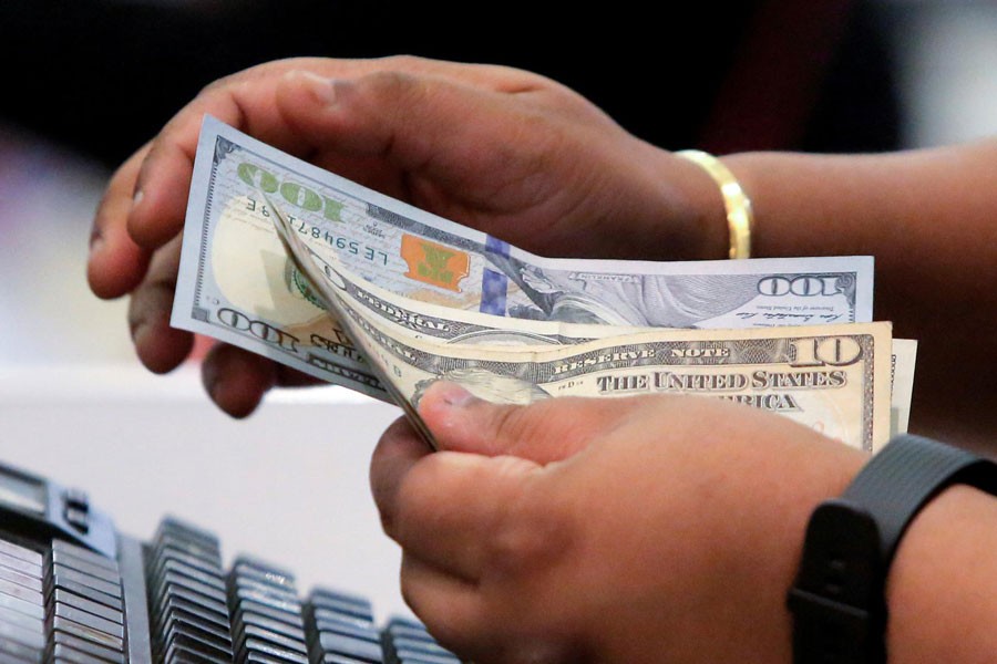 A cashier handling money in Macy's Herald Square in Manhattan, New York, US 	— Reuters