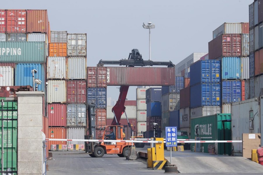 A container is carried onto a truck in a logistics centre near Tianjin Port, in northern China, May 16, 2019. Reuters