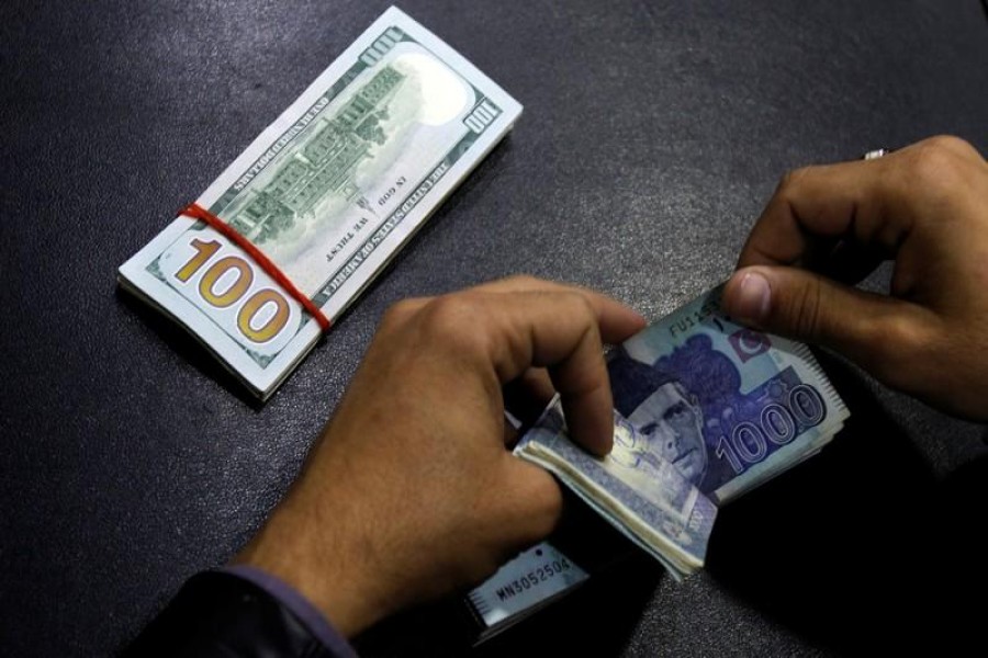 A currency trader counts Pakistani rupee notes as he prepares an exchange of U.S dollars in Islamabad, December 11, 2017. Reuters/Files