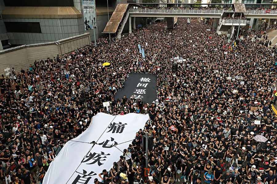 Huge crowds march in Hong Kong, demand leader step down