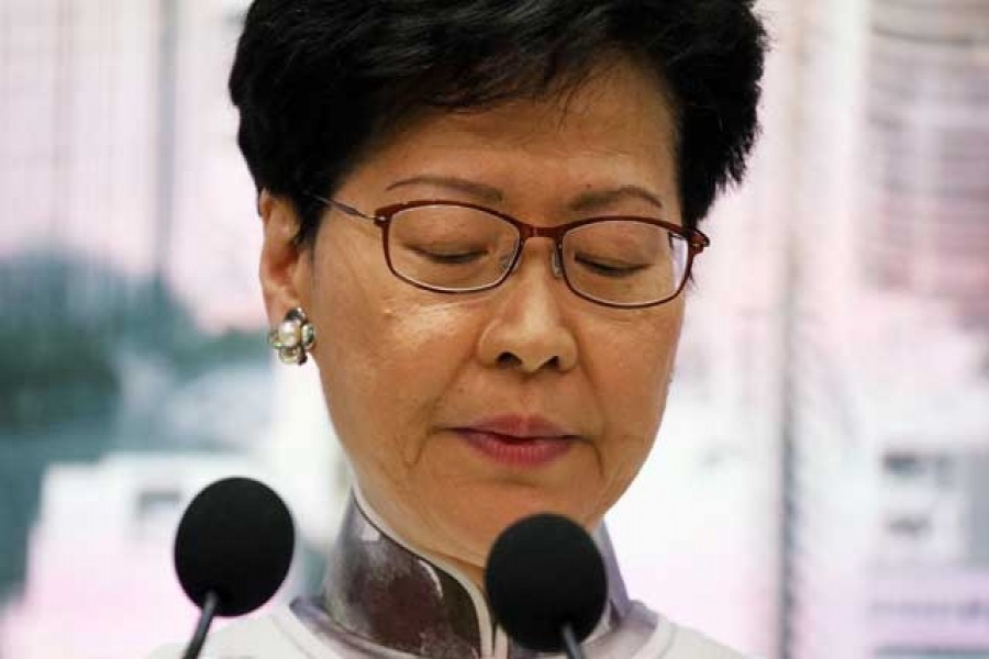 Hong Kong leader says sorry as protesters insist she quits