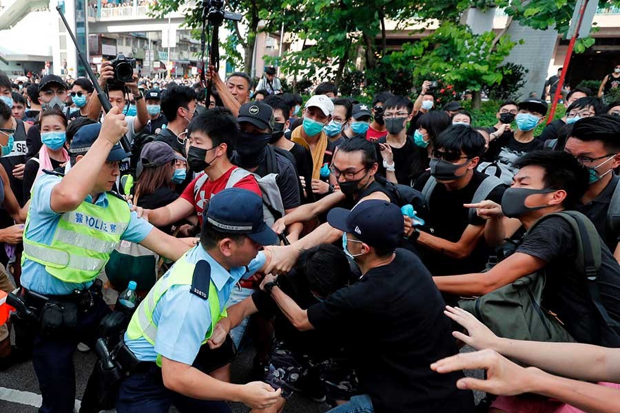 Hong Kong protesters march near border to target traders from China