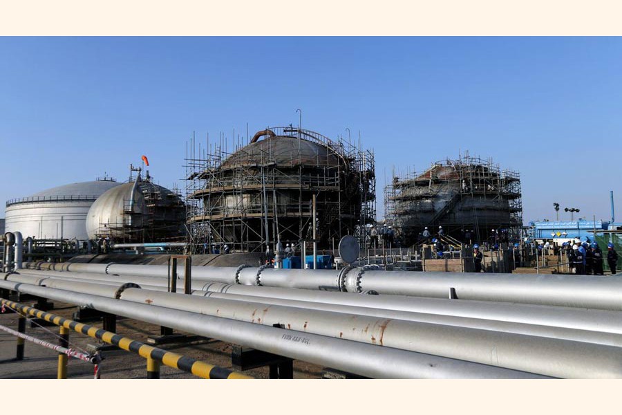 Workers are seen at the damaged site of Saudi Aramco oil facility in Abqaiq, Saudi Arabia                                        	— Reuters