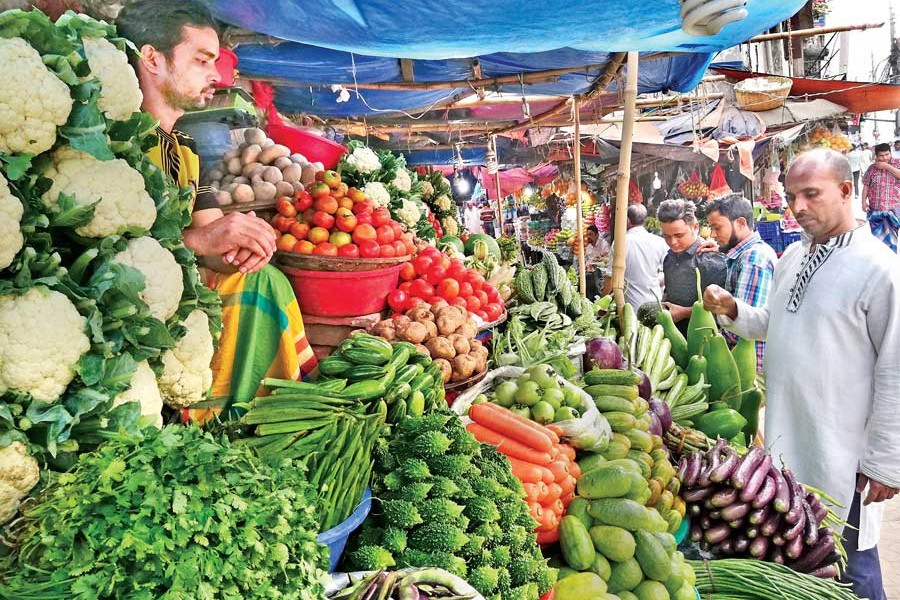 Customers shopping for kitchen items at a market at Shantinagar in the city on Friday — FE photo