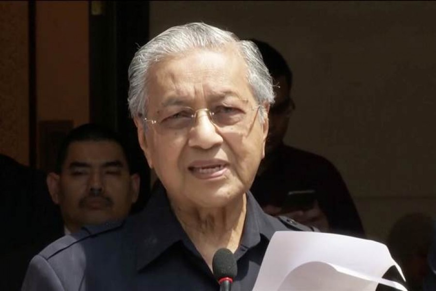 Mahathir resigns but asked to stay as interim PM