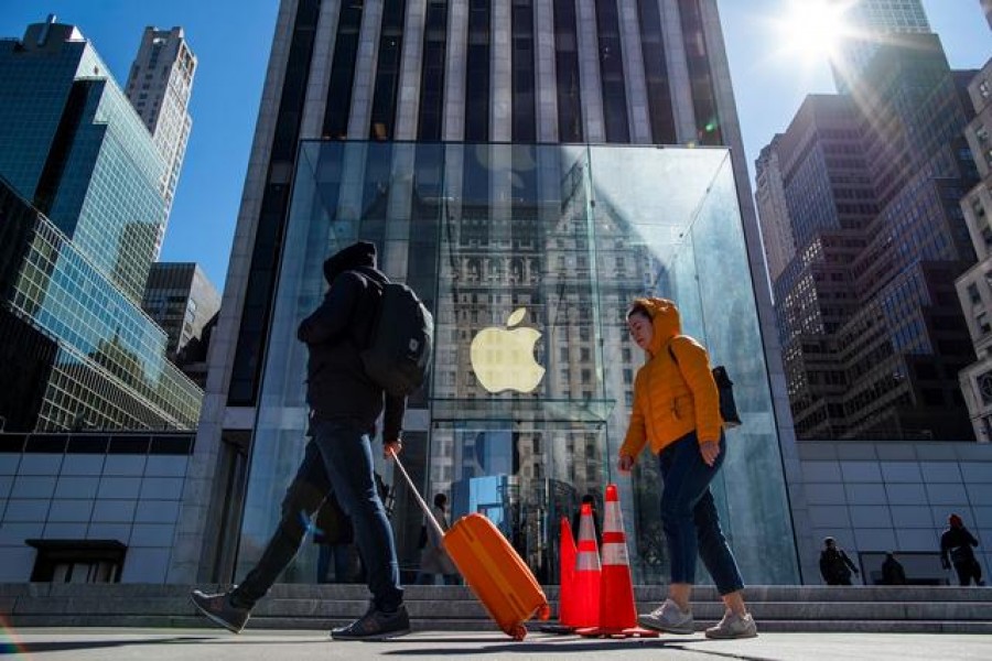 People pass by an Apple store in 5av as it's closed to public due to coronavirus disease (Covid-19) in New York City, New York, US on March 14, 2020 — Reuters photo