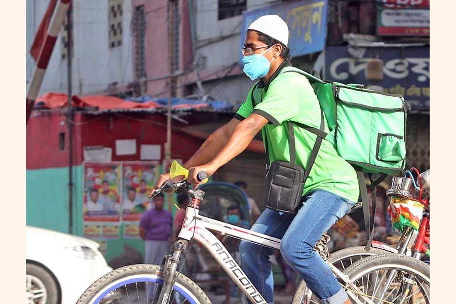 A file photo shows a biker delivering food in the city recently--FE photo