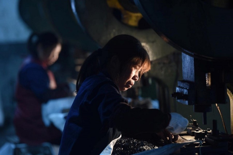 Employees work on a production line manufacturing metal parts for furniture at a factory in Hangzhou, Zhejiang province, China April 30, 2020. — China Daily via Reuters/Files