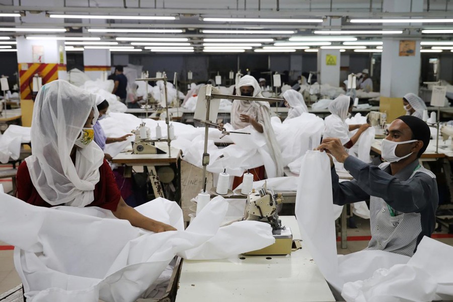 Bangladeshi garment workers make protective suit at a factory amid concerns over the spread of the coronavirus disease (COVID-19) in Dhaka, Bangladesh on March 31, 2020 — Reuters/Files