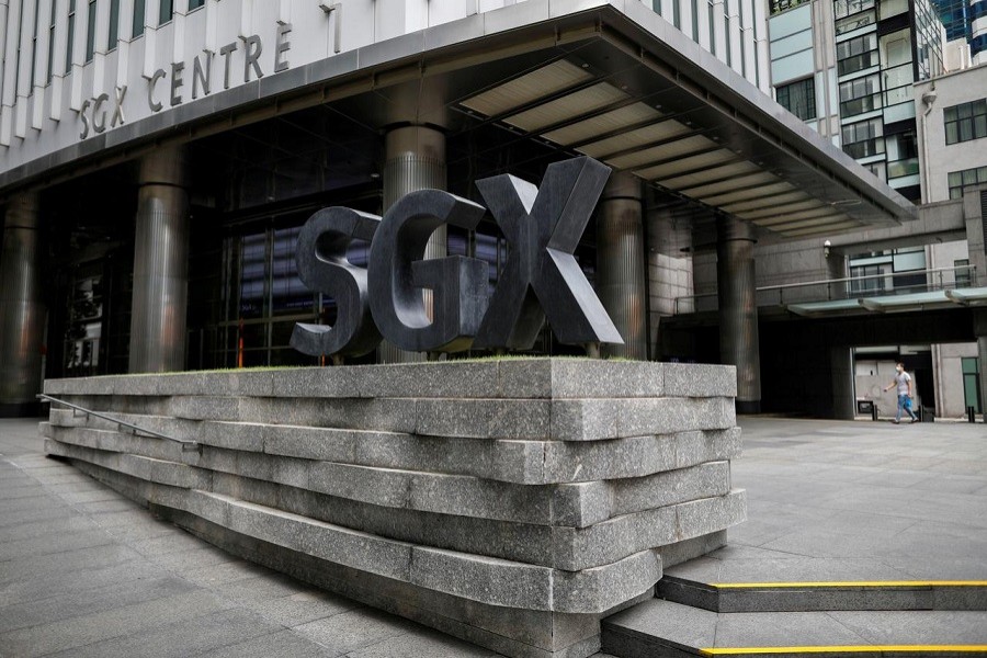 A man wearing a protective face mask walks past the Singapore Exchange (SGX) which stays open during "circuit breaker" measures to curb coronavirus COVID-19) in central business district area in Singapore, April 07, 2020. — Reuters/Files