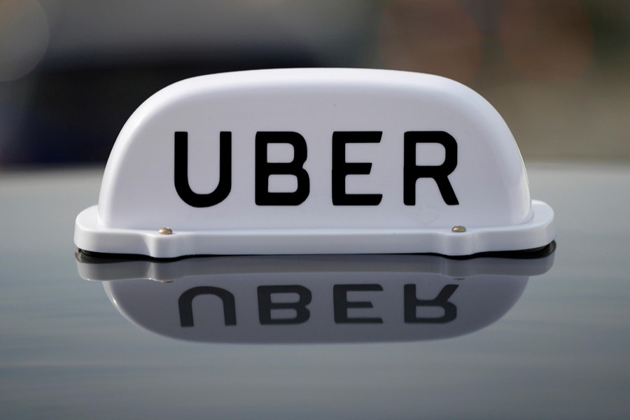 The Logo of taxi company Uber is seen on the roof of a private hire taxi in Liverpool, Britain on April 15, 2019 — Reuters/Files