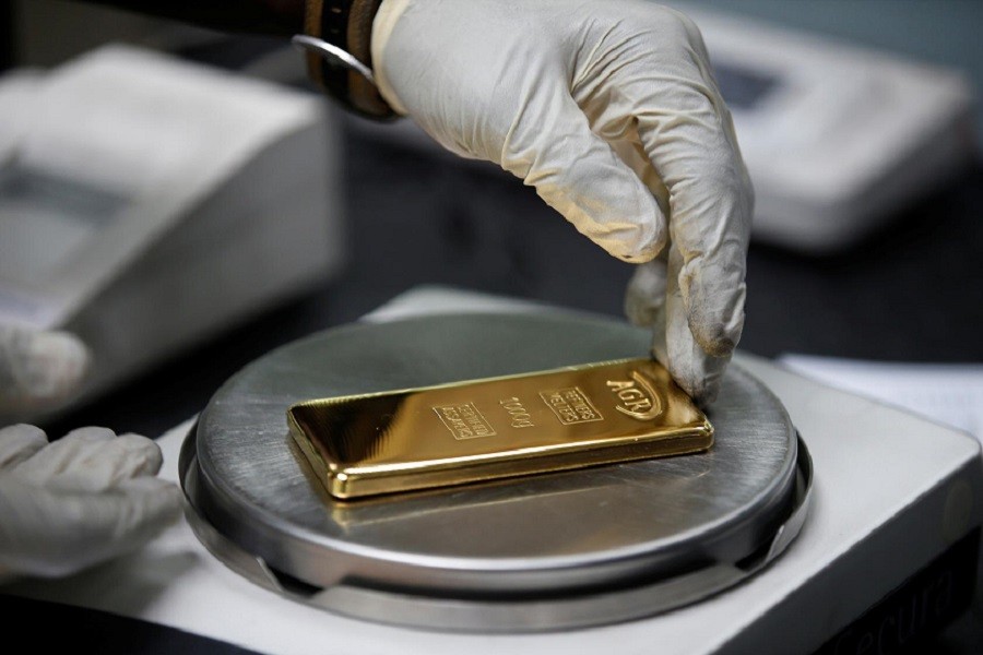 Gold rises to nine-year peak on stimulus bets, silver soars
