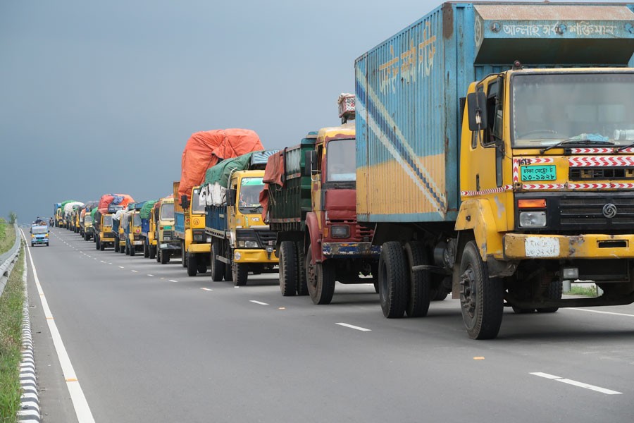 Trucks laden with goods are in a long queue before entering into a ferry. Trade is one of the core drivers of Bangladesh economy. 	—FE Photo