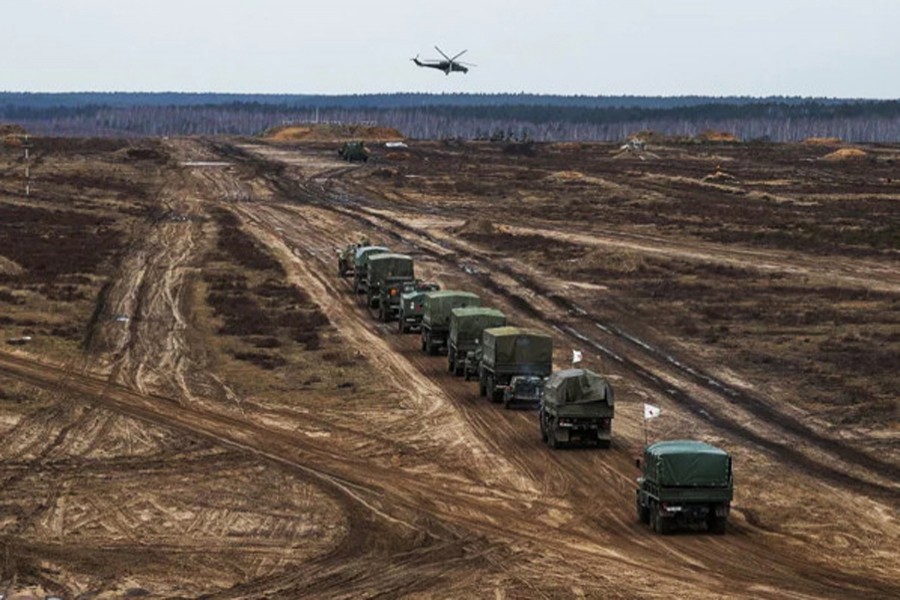 A helicopter flies over troops during joint military drills of Russia and Belarus (Reuters)