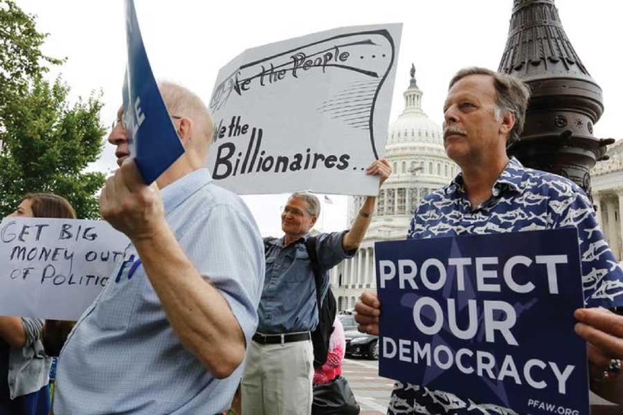 Supporters look on at a news conference led by Democratic senators and congressmen in support of a proposed constitutional amendment for campaign finance reform, on Capitol Hill in Washington September 08, 2014.  —Reuters