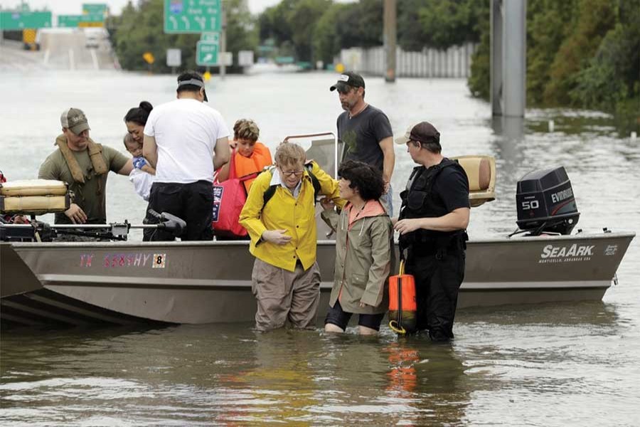 Rescuers with Houston residents evacuated from their flooded homes during Tropical Storm Harvey.    — AP photo