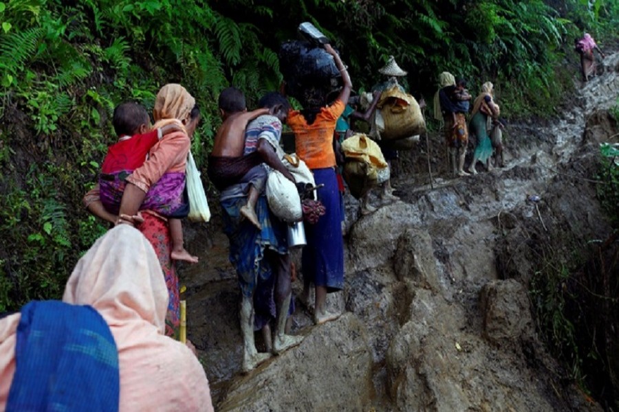 Rohingya refugees climb up a hill after crossing the Bangladesh-Myanmar border in Cox's Bazar, Bangladesh Sept 8, 2017. Reuters