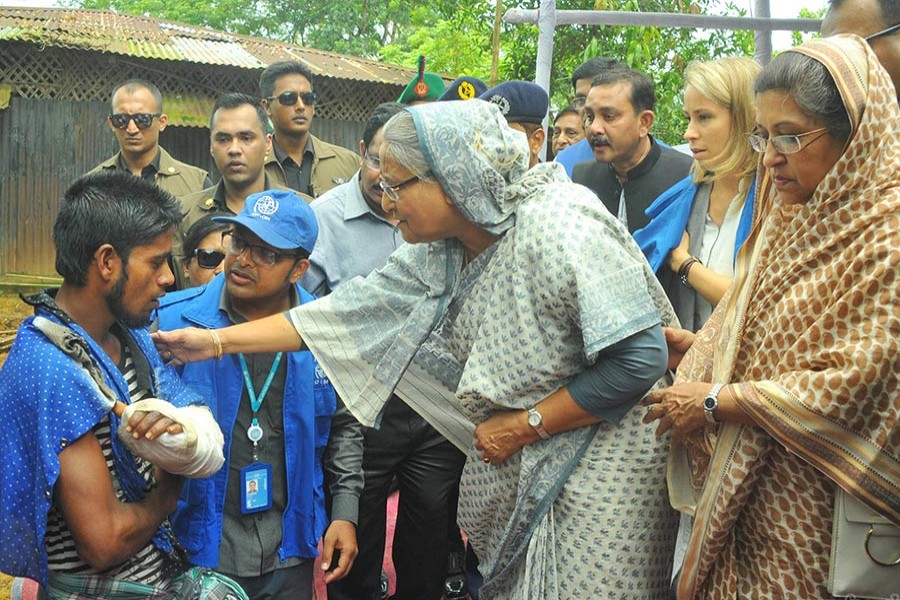 Prime Minister Sheikh Hasina interacts with Rohingyas, who escaped from Rakhine unrest, at Cox's Bazar’s Kutupalong refugee camp on Tuesday. She was accompanied by her sister Sheikh Rehana among others during the visit. - Focus Bangla photo