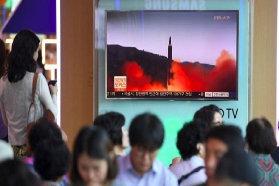 A missile is seen taking off from a grassy field in a burst of burning fuel and smoke. Photo: KCNA