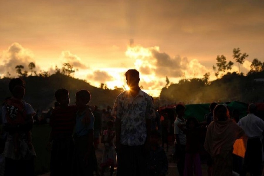 Rohingya refugees wait roadside for aid at Thaingkhali makeshift refugee camp in Cox's Bazar, Bangladesh, September 14, 2017. Reuters