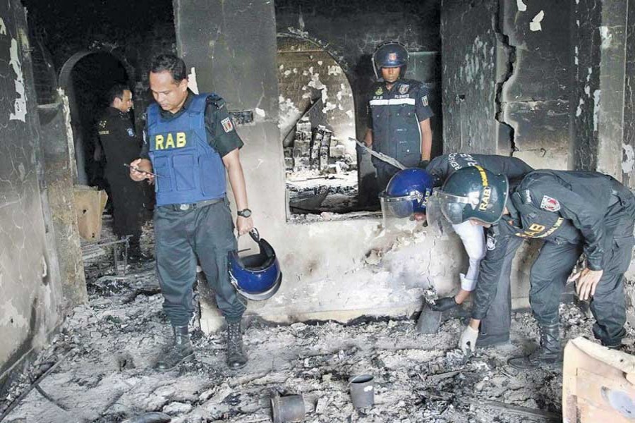 RAB members examine on September 07, 2017 the place where militants had exploded bombs at Komol Prova, Mirpur, Dhaka.