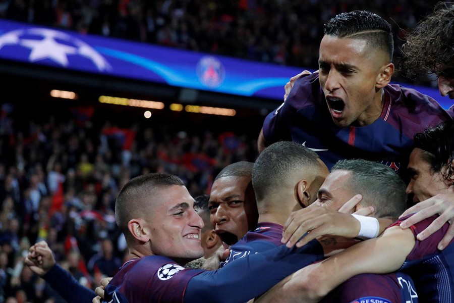 Paris Saint-Germain’s Dani Alves celebrates scoring their first goal with team mates. - Reuters photo