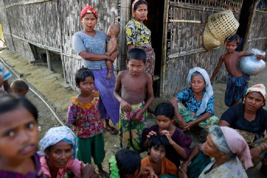 Rohingya Muslims pass time near their shelter at a refugee camp outside Sittwe June 4, 2014. Reuters