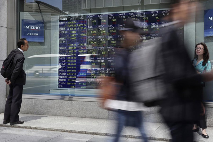 A man looks at an electronic stock indicator of a securities firm in Tokyo. - AP file photo