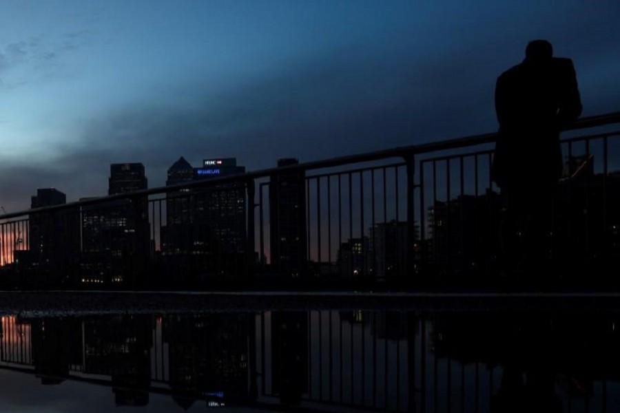 A man looks towards the Canary Wharf business district in London, Britain December 11, 2016. Reuters/File Photo