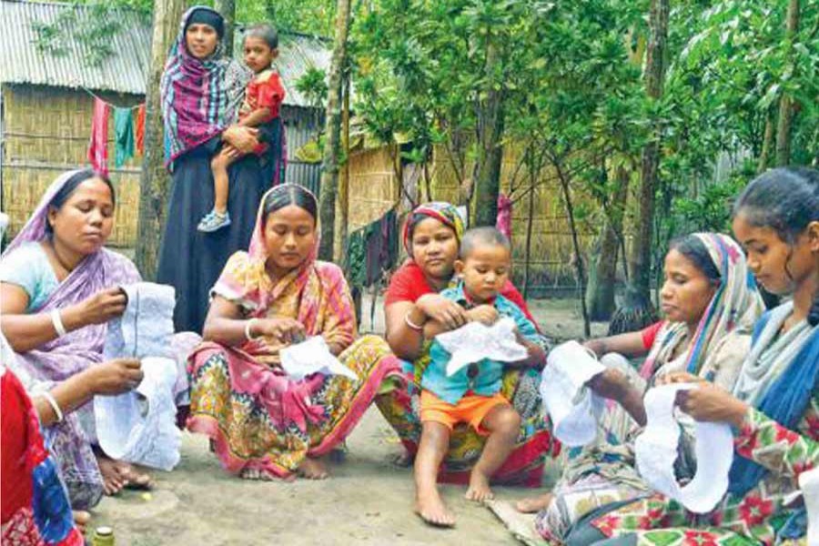 Village women make fancy caps in Alambiditor area of Gangachara upazila of Rangpur. The photo was taken on Tuesday. 	— FE Photo