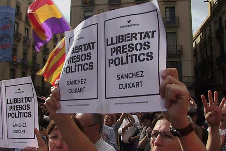 Thousands of people gathered outside Catalonia's regional parliament in Barcelona on Thursday. - BBC