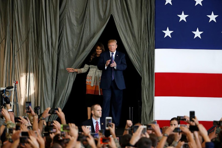 US President Donald Trump arrives with first lady Melania Trump to address members of US military services and Japan Self-Defense Force (JSDF) at US Air Force Yokota Air Base in Fussa, Tokyo, Japan on Sunday. - Reuters photo