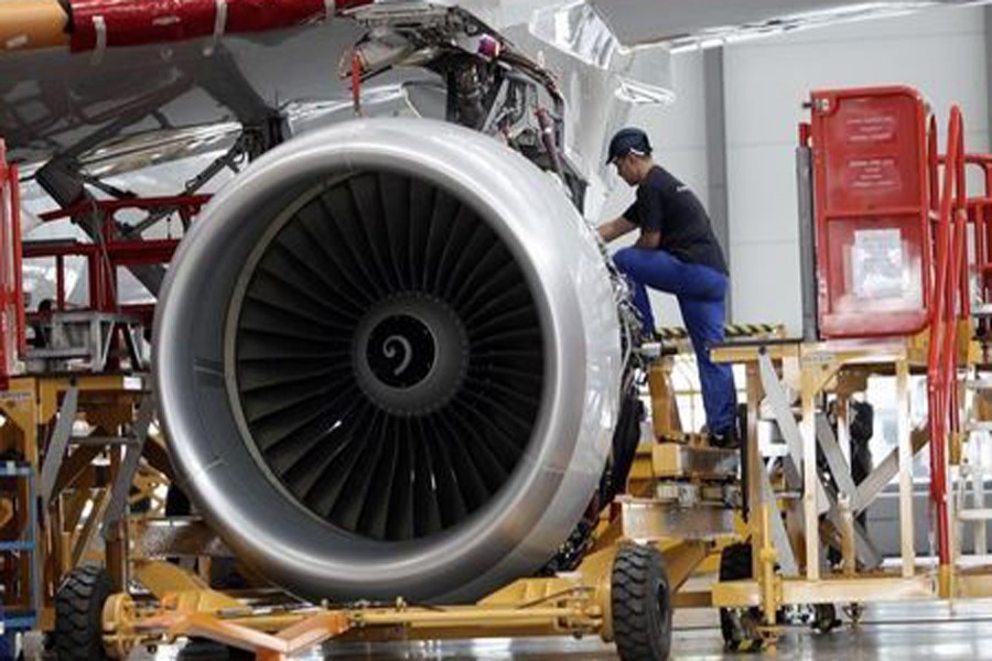 An employee installs an engine for an A320 plane under construction at the final assembly line of Airbus factory in Tianjin municipality. 	— Reuters