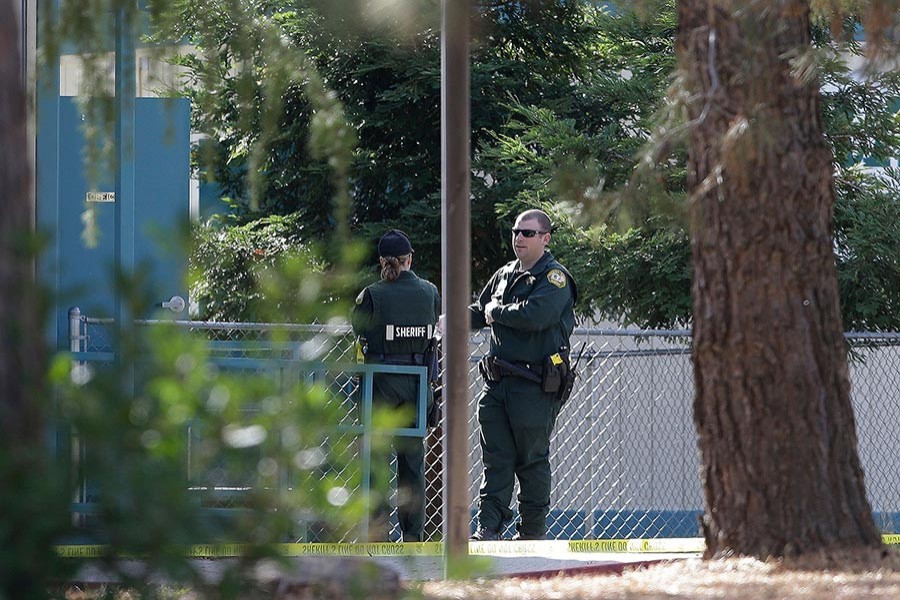 Law enforcement officers are seen at an elementary school in the community of Rancho Tehama Reserve, where a gunman opened fire on Tuesday in California. - AP photo