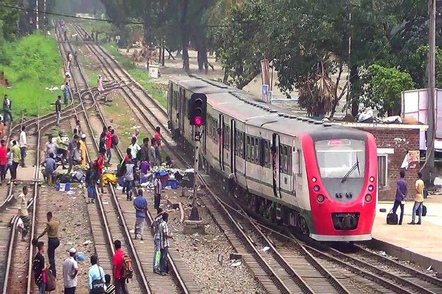 Train kills bank official, child narrowly saved