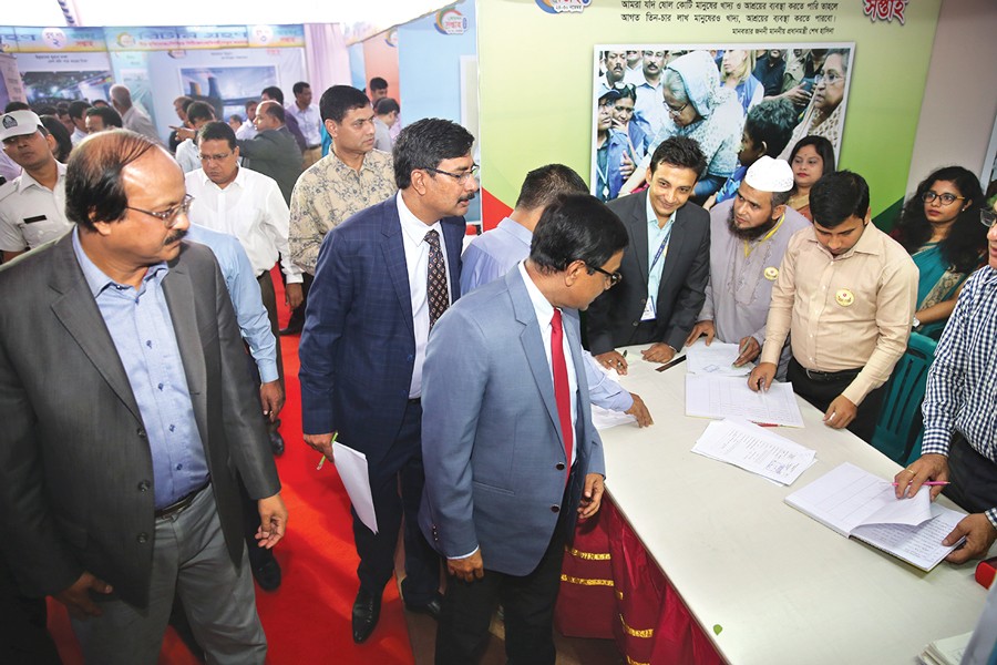 NBR Chairman Nojbur Rahman inspecting the Income Tax Week premises at Segunbagicha in Dhaka, which began on Friday	— FE Photo