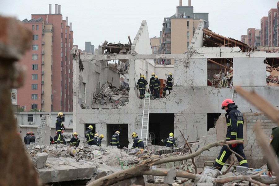 NINGBO: Rescue workers work at the site of a blast in Ningbo of Zhejiang province on Sunday.	— Reuters