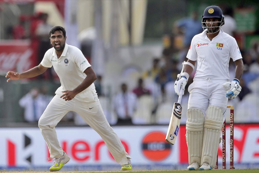 Ravichandran Ashwin, left, celebrates the dismissal of Sri Lanka's Upul Tharanga during their second cricket test match. | AP