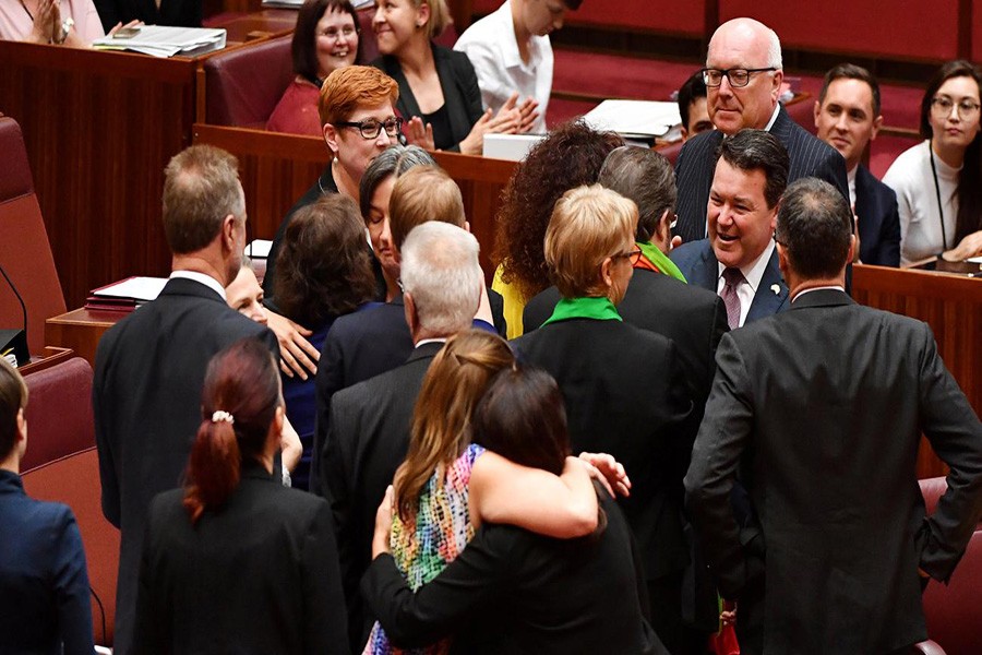 Liberal Senator Dean Smith is congratulated after the vote for the same-sex marriage bill in the Senate chamber at Parliament House in Canberra November 29, 2017. Photo:  REUTERS