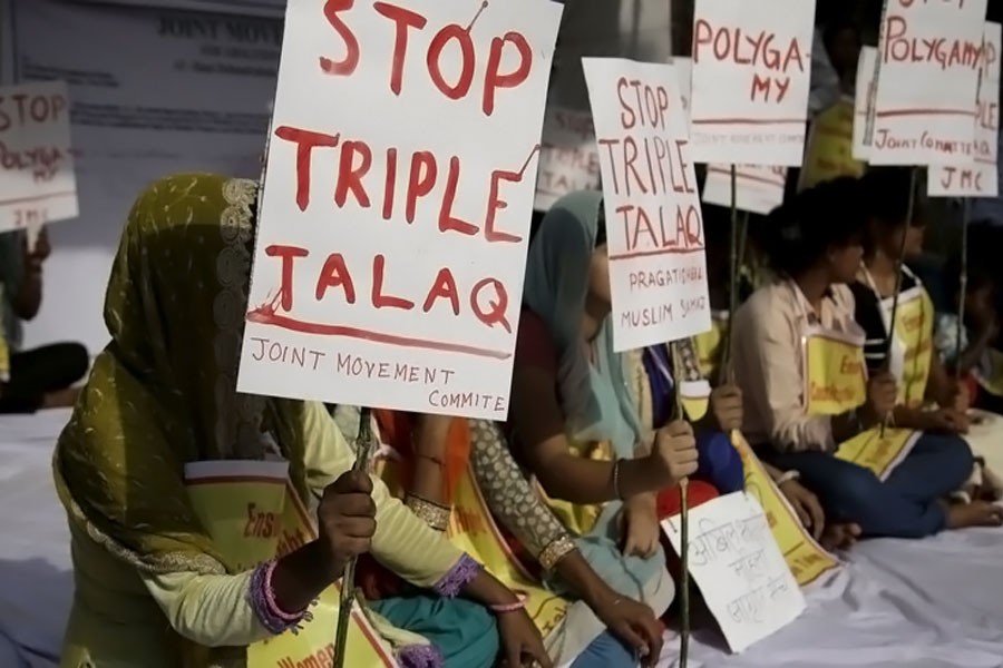 Activists hold signs during a protest against "triple talaq," the practice of instant divorce by Muslim men, in New Delhi on May 10. The country's Supreme Court has outlawed this means of ending a marriage. (AP photo)