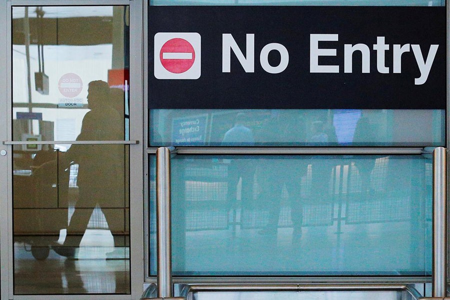 International travellers (reflected in a closed door) arrive at Logan Airport in Boston, Massachusetts, US on June 29 last. - Reuters file photo