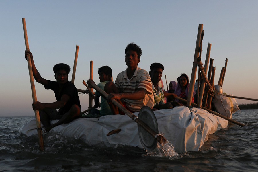 Rohingya refugees sail on an improvised raft across the Naf River to reach Bangladesh, in Teknaf, Bangladesh, November 29, 2017 last. - Reuters photo