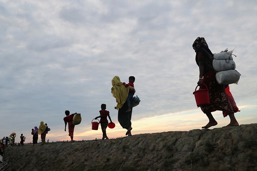 Rohingya refugees walk after crossing the Naf River with an improvised raft to reach to Bangladesh in Teknaf, Bangladesh, November 12 last. - Reuters file photo