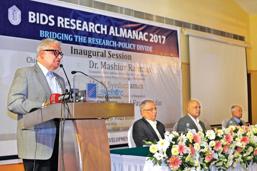 Dr Mashiur Rahman, Economic Affairs Adviser to the Prime Minister, addresses the inaugural session of "BIDS Research Almanac 2017: Bridging the Research Policy Divide" in the city on Wednesday. — FE photo