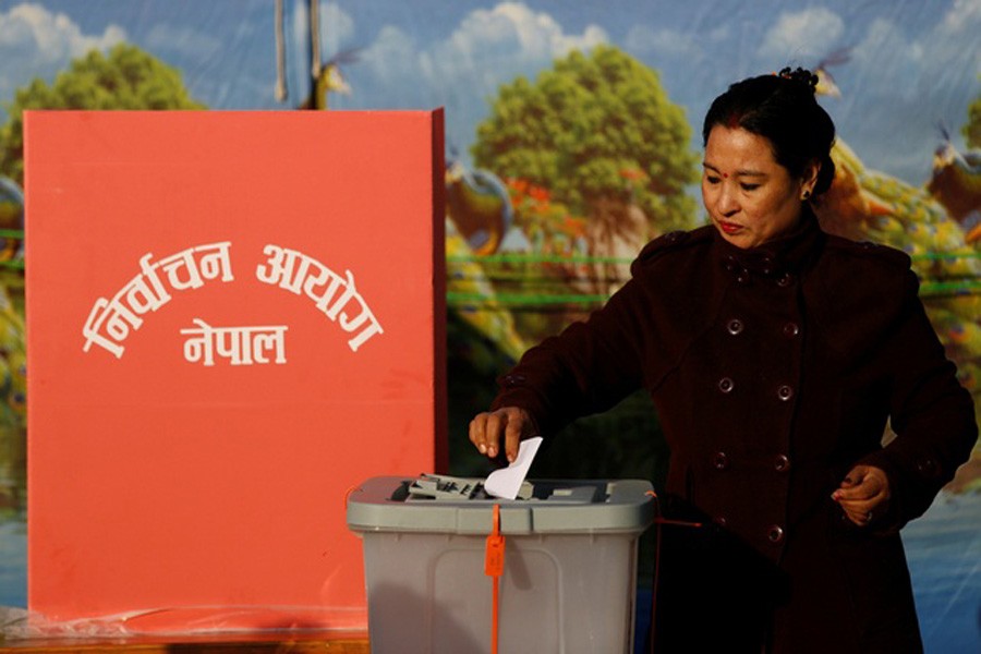 A woman casts her vote during the parliamentary and provincial elections in Bhaktapur, Nepal Dec 7, 2017. Reuters