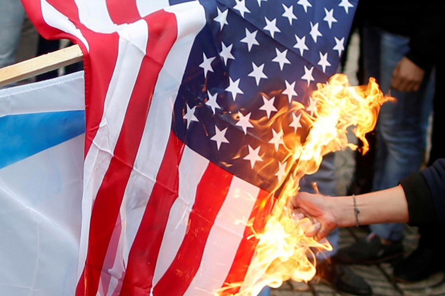 A Palestinian demonstrator burns a US flag during a protest in Gaza City on Wednesday. - Reuters photo