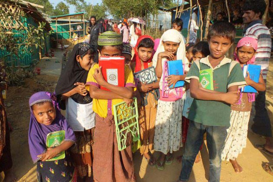 A group of Rohingya children emerge from a nearby religious school in Kutupalong camp. 	Photo: Naimul Haq/IPS