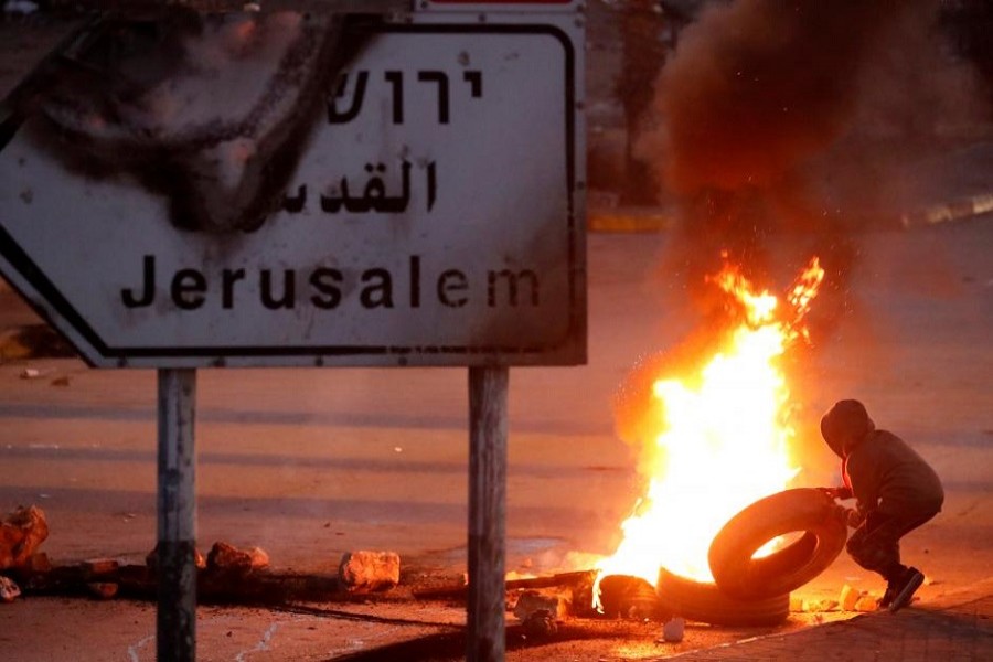 A Palestinian protester sets up a burning barricade near the West Bank city of Ramallah December 8, 2017. Reuters