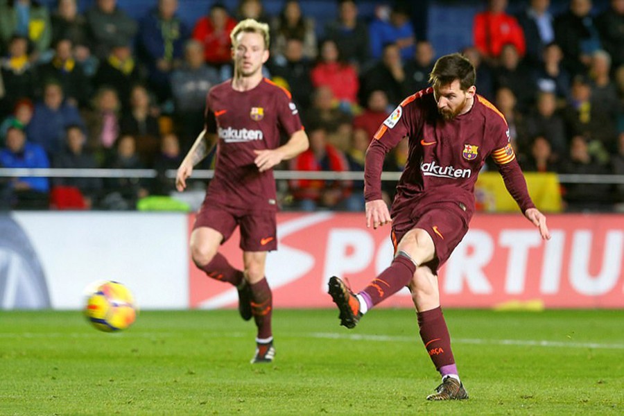 Lionel Messi buries the ball beyond Sergio Asenjo in the Villarreal goal to double Barcelona's lead during Sunday's encounter. - Reuters photo